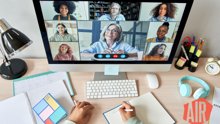 A video monitor with people smiling and video conferencing